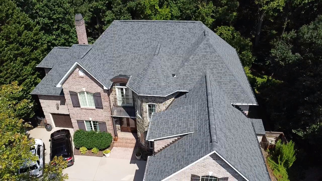 Front aerial view of a completed gray architectural-shingle roof restoration