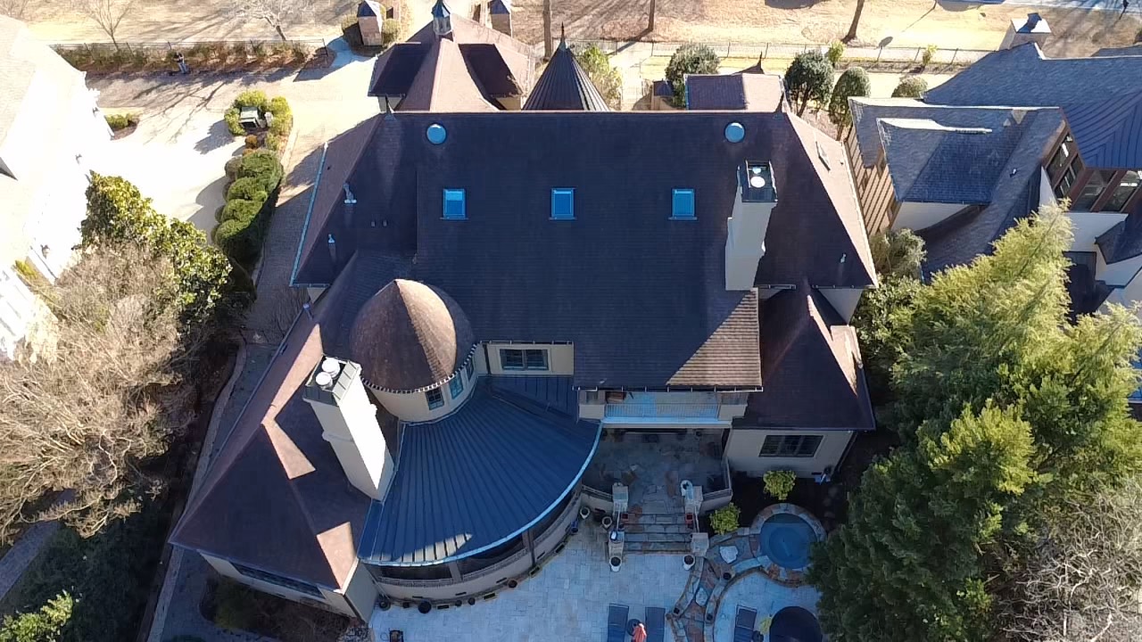 Rear aerial view of a Palisades roof with skylights and complex rooflines